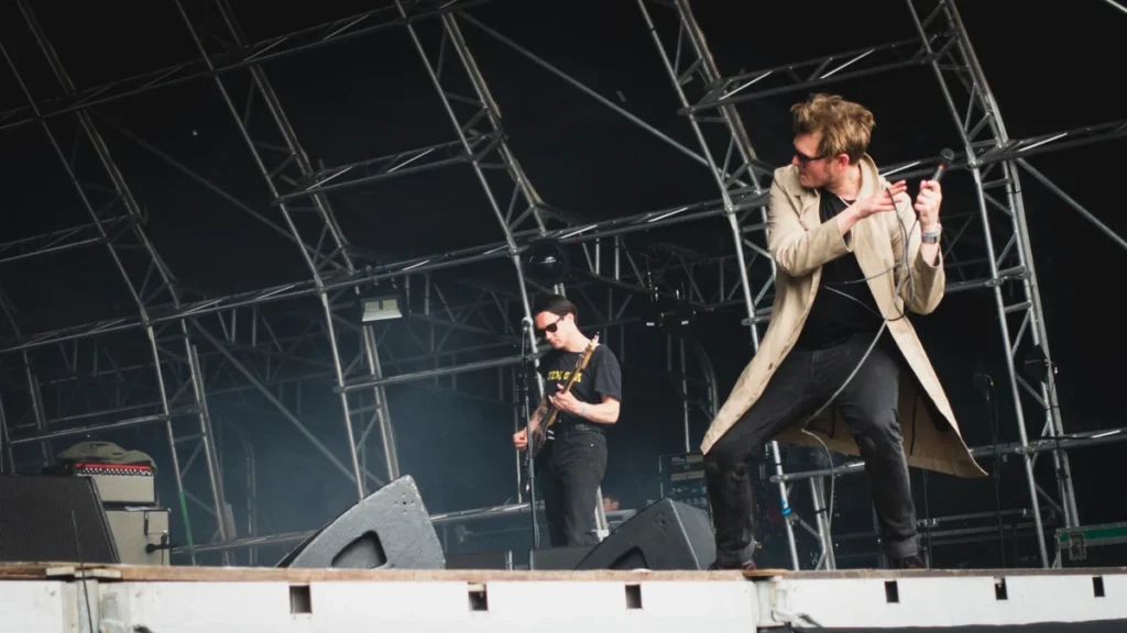 Yard Act performing on a festival stage