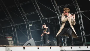 Yard Act performing on a festival stage