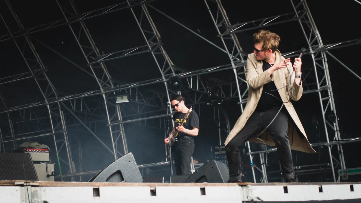 Yard Act performing on a festival stage